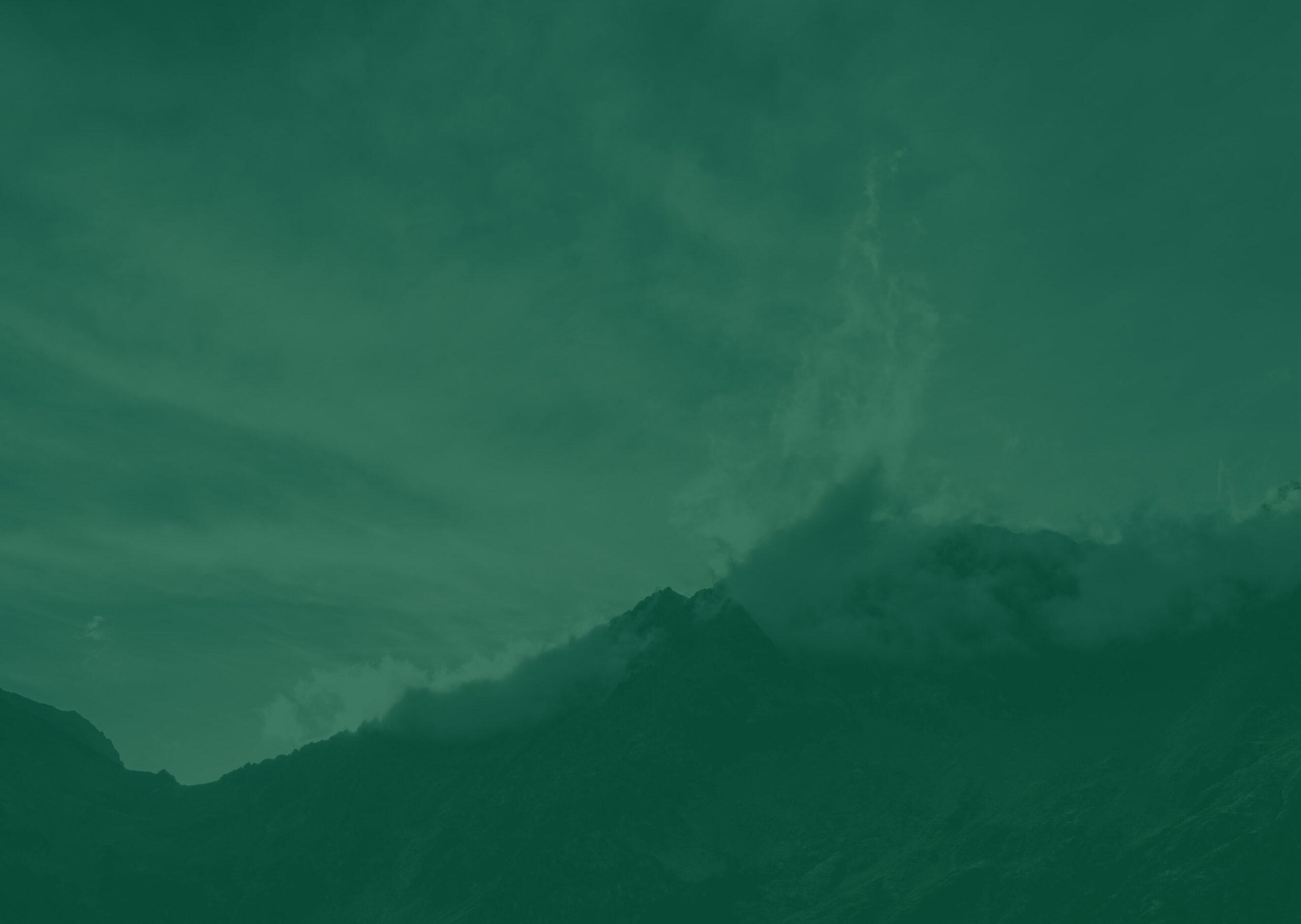 A mountain with the sky in the background with a green filter over it